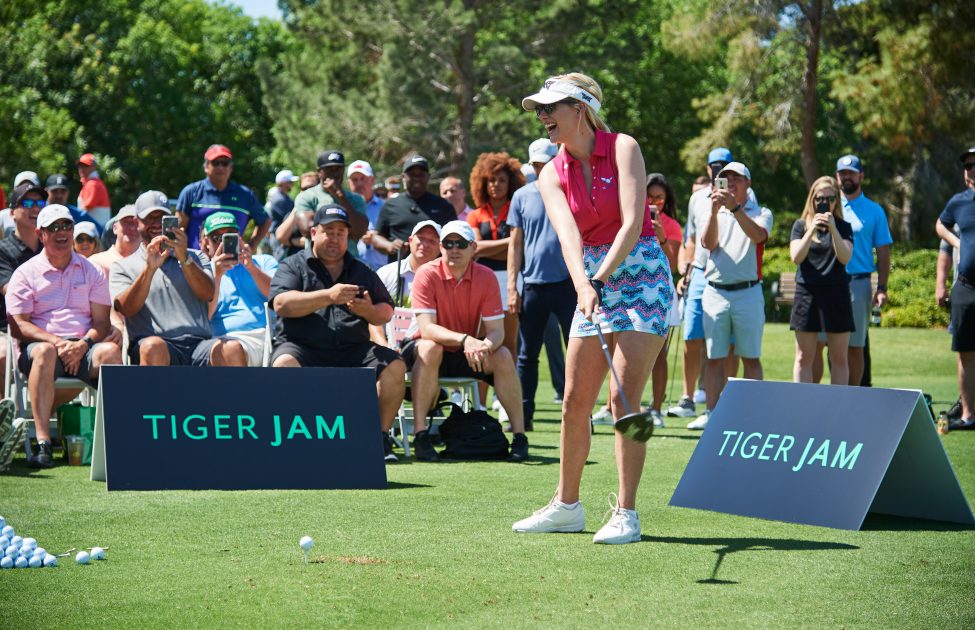 Paige Spiranac takes a swing during Tiger's golf exhibition
