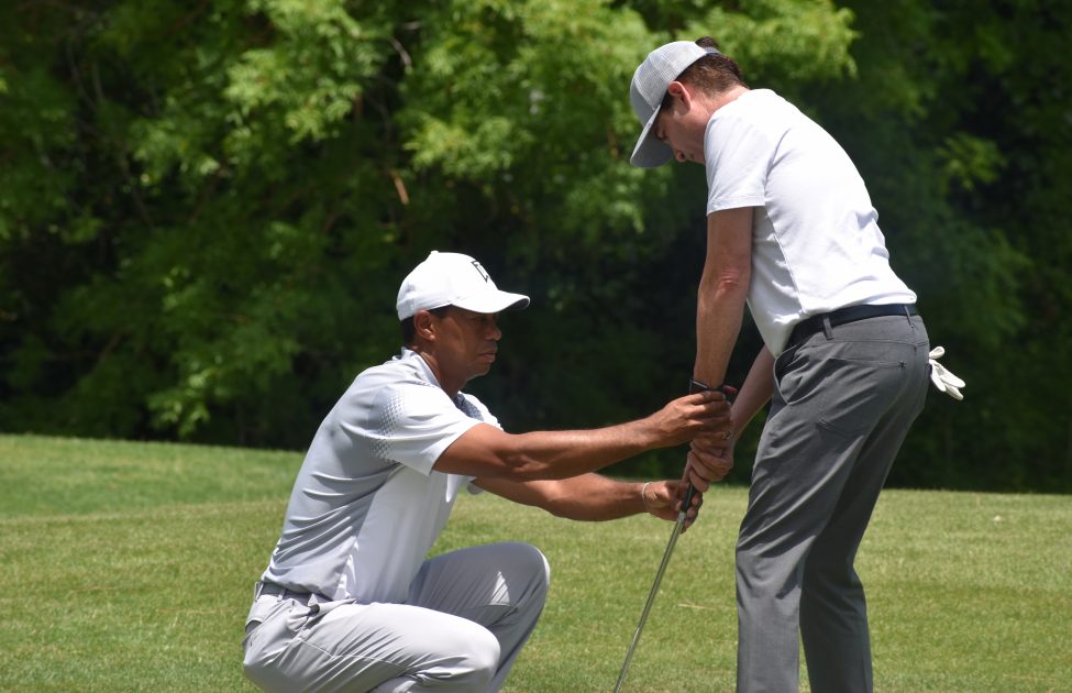 Tiger Woods gives Pat Monahan of Train golf lessons